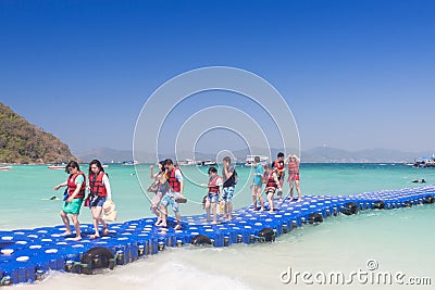 Tourists walking on blue pontoon to the beach at Coral Island P Editorial Stock Photo