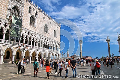 Tourists walking by Doge`s Palace on Piazzetta San Marco in Veni Editorial Stock Photo