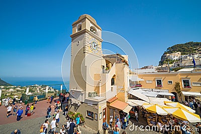 Tourists walking near clock tower on Piazza Umberto, knows as La Piazzetta, Capri Island, Italy Editorial Stock Photo