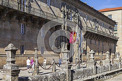 Tourists walking in the Obradoiro Square in front of the Hostal de Los Reyes Católicos. Santiago de Compostela, Galicia, Spain. Editorial Stock Photo