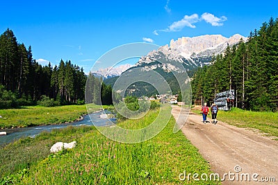 Tourists walking scenic path in Dolomites Stock Photo