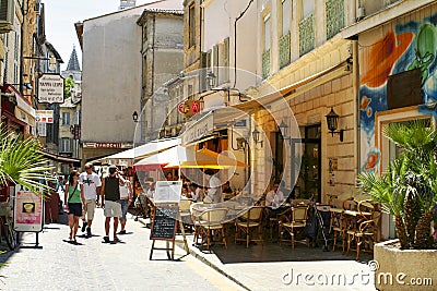 Tourists walking in a street in Avignon, a city in southeastern France Provence region, set on the Rhone River Editorial Stock Photo