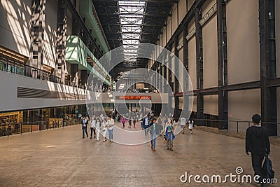 Tourists walking in Turbine Hall of Tate Modern Museum at London Editorial Stock Photo