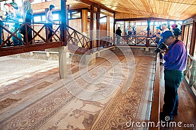 Tourists walking and watching ancient floor mosaic. Kourion was an ancient city on the southwestern coast of Cyprus Editorial Stock Photo