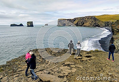 Tourists watching Dyrholaey Arch in south Iceland Editorial Stock Photo