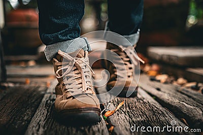 Tourists wear boots and walk on wooden Stock Photo