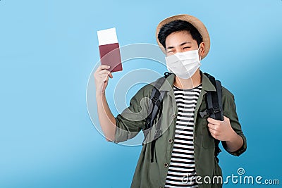 Tourists wear masks and carry passports and are excited about the new tour. On a blue background in the studio Stock Photo