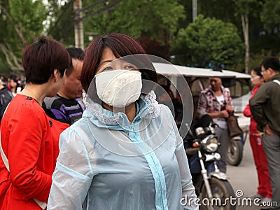 Tourists in xi 'an wearing a mask to hide to admire the view micrometeorology pollution advocate healthy to swim Editorial Stock Photo