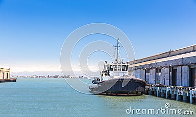 Tow ship in harbor of seaport. Stock Photo