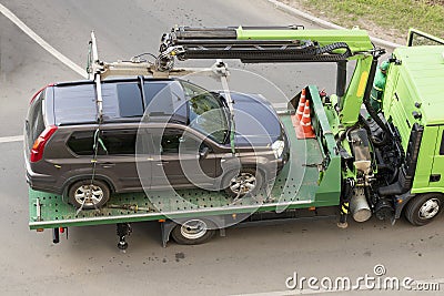 Tow truck evacuates the car for improper parking. Stock Photo