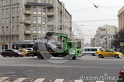 Tow truck `Moscow Parking` carries the car to the impound lot. Editorial Stock Photo