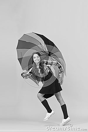 Towards knowledge. Schoolgirl with backpack. Schoolgirl daily life. Girl with umbrella. Rainy day. Happy childhood. Kid Stock Photo