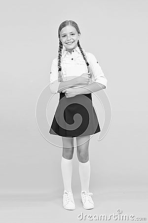 Towards knowledge. small girl in school uniform. dictionary notebook. Get information. reading story. childrens Stock Photo