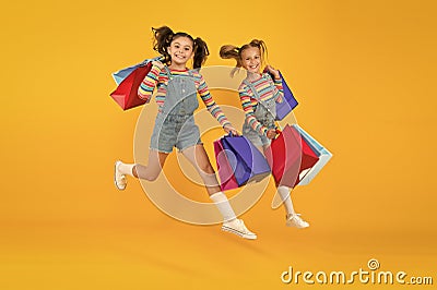 Towards purchase. Modern fashion. Kids fashion. Cute children hurry up for sale season. Discount and sale. Little girls Stock Photo