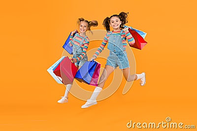 Towards purchase. Modern fashion. Kids fashion. Cute children hurry up for sale season. Discount and sale. Little girls Stock Photo