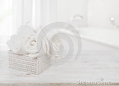 Towels and bath sponge in box over blurred bathroom background Stock Photo