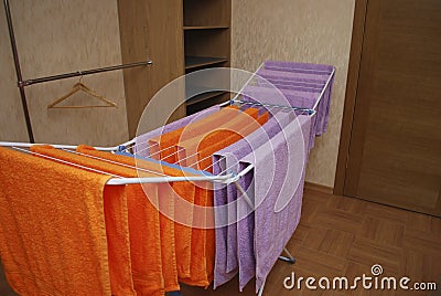 Towels dry on a metal dryer. Stock Photo