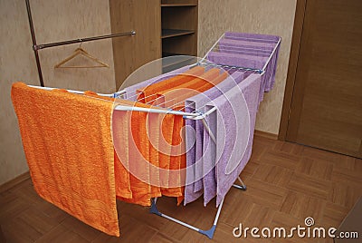 Towels dry on a metal dryer. Stock Photo