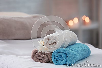 Towels and flowers on massage table Stock Photo