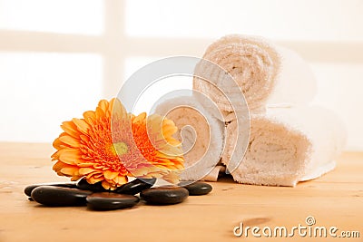 Towels and masage rocks on table in spa salon Stock Photo