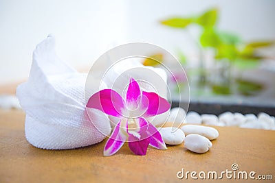 Towels and orchid with pebbles in spa Stock Photo