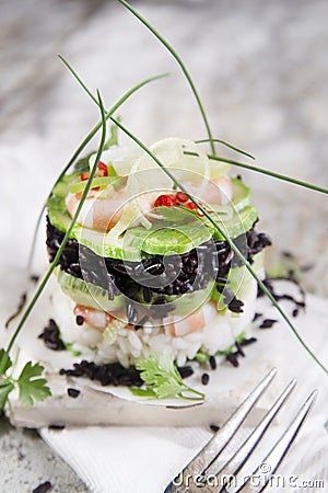 Tower of black and white rice with shrimp and zucchini Stock Photo
