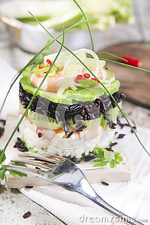 Tower of black and white rice with shrimp and zucchini Stock Photo