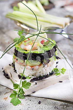 Tower of black and white rice with shrimp and zucchini Stock Photo