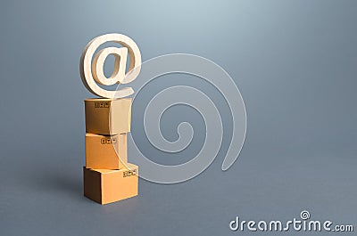 Tower of boxes and email internet symbol. Online Internet distribution of goods. E-commerce. Network marketing advertising Stock Photo