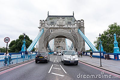 Tower Bridge in central London with people and traffic. Looking straight down the centre of the bridge. Editorial Stock Photo