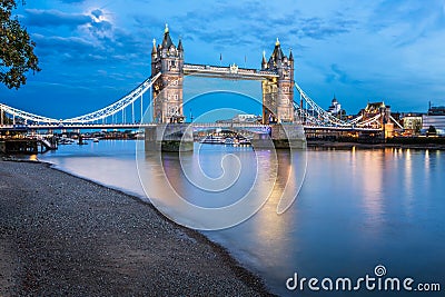 Tower Bridge and Thames River Lit by Moonlight at the Evening Stock Photo