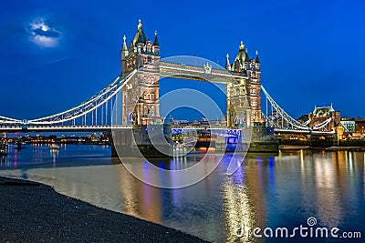 Tower Bridge and Thames River Lit by Moonlight at the Evening Stock Photo