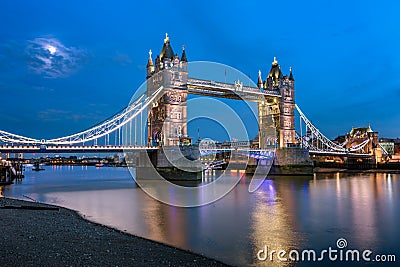 Tower Bridge and Thames River Lit by Moonlight at the Evening Stock Photo