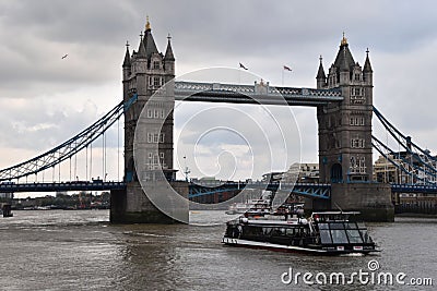 Tower Bridge and touristic boat in London Editorial Stock Photo