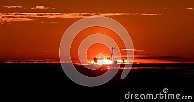 Tower crane against the backdrop of the setting sun. Backlight. Ekaterinburg, Russia Stock Photo