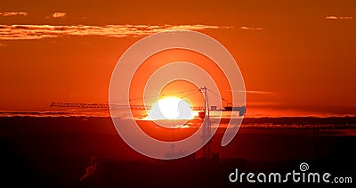 Tower crane against the backdrop of the setting sun. Backlight. Ekaterinburg, Russia Stock Photo