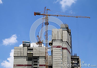 Tower cranes on a construction with blue sky. Stock Photo