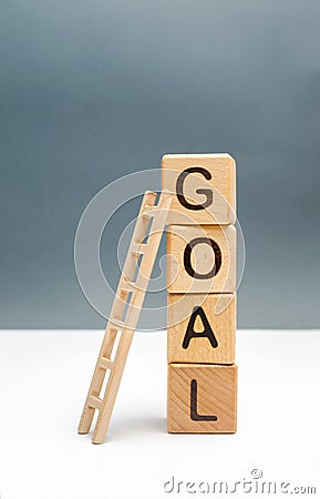 tower of cubes with an inscription goal and a up ladder. The concept of achieving the goal, subject to the application of all Stock Photo