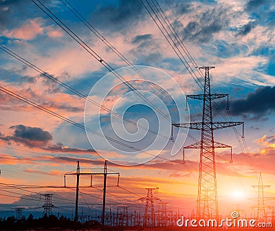 Tower electrical lines are silhouette on beautiful sunset. Stock Photo