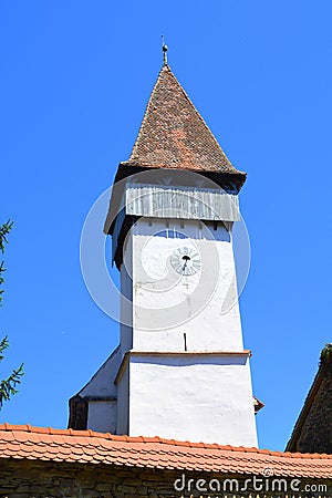 Tower of the fortified medieval saxon evangelic church in the village Mesendorf Meschenderf, Meschendorf, Mesche Stock Photo