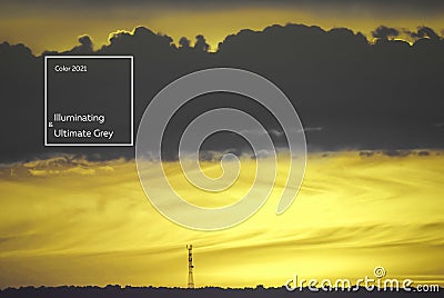 Tower on the horizon against the background of the setting sun in the color of the year 2021 illuminating and Ultimate Gray Editorial Stock Photo