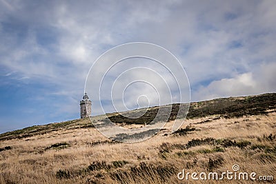 A tower on the moors with a winter sky. Stock Photo