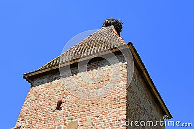Tower and nest. Typical rural landscape and peasant houses in the village Alma Vii Almen Transylvania, Romania Stock Photo