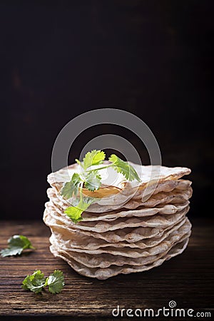 Tower thin crispy loaves of useful home cakes with chick-pea flour for vegetarinskogo and healthy eating. On a dark Stock Photo