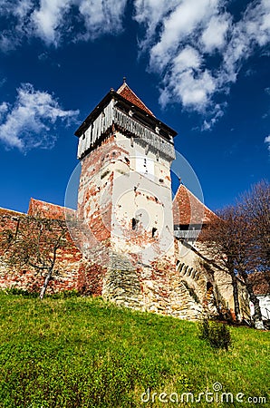 Tower and walls of fortified church Alma Vii, Transylvania. Romania Stock Photo
