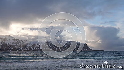 Towering clouds from Ramsberg beach on Flakstad island on the Lofoten islands in winter at sunset Stock Photo