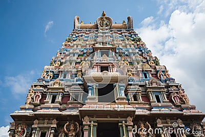 towering gopuram of the temple, rising above the entrance gate Stock Photo