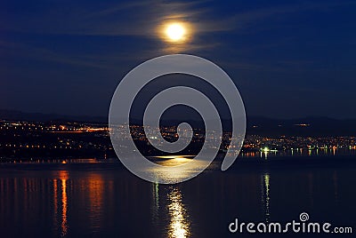 Town on the coast at night with moon Stock Photo
