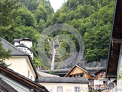 Town Hallstatt with mountain waterfall. Alpine massif, beautiful canyon in Austria. Stock Photo