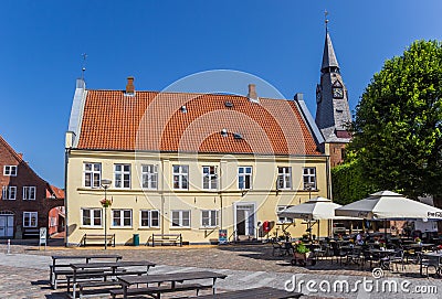 Town square with restaurant and church tower in Tonder Editorial Stock Photo